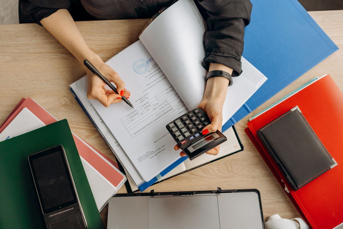 Financial documents and a calculator viewed from above
